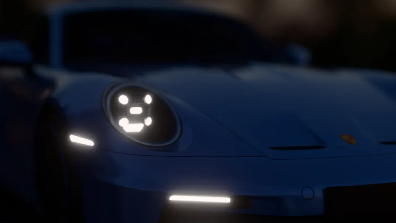 Close-up of the GT3's headlight at night, its four LED points glowing, the rest of the car out of focus