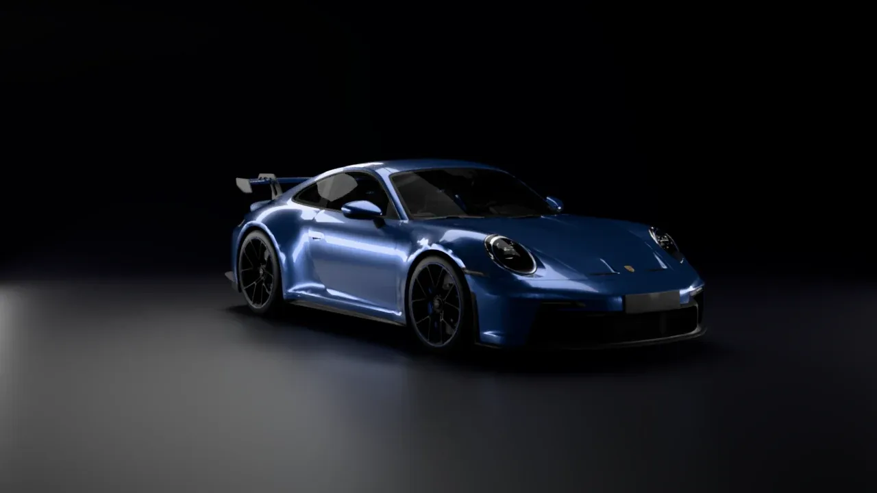 A blue Porsche 911 GT3 in a dark studio, front three-quarter view, with soft highlights on its hood and flank